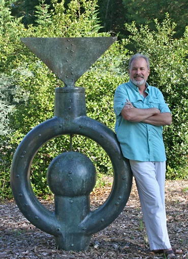 Master sculptor Marc Staples standing next to one of his creations